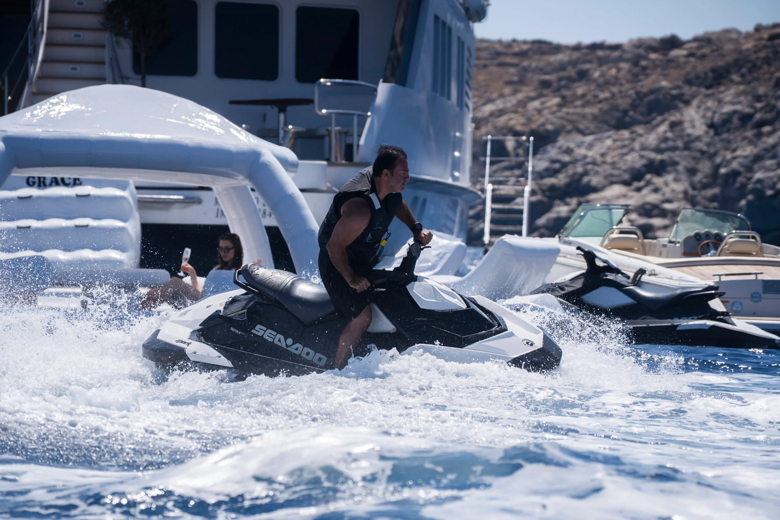 Grace Yacht cruising in Dubai waters with Jet Ski activity in the foreground