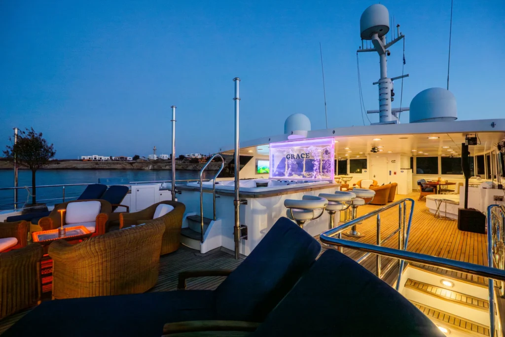 Evening ambiance on the deck of Grace Yacht with bar and seating area